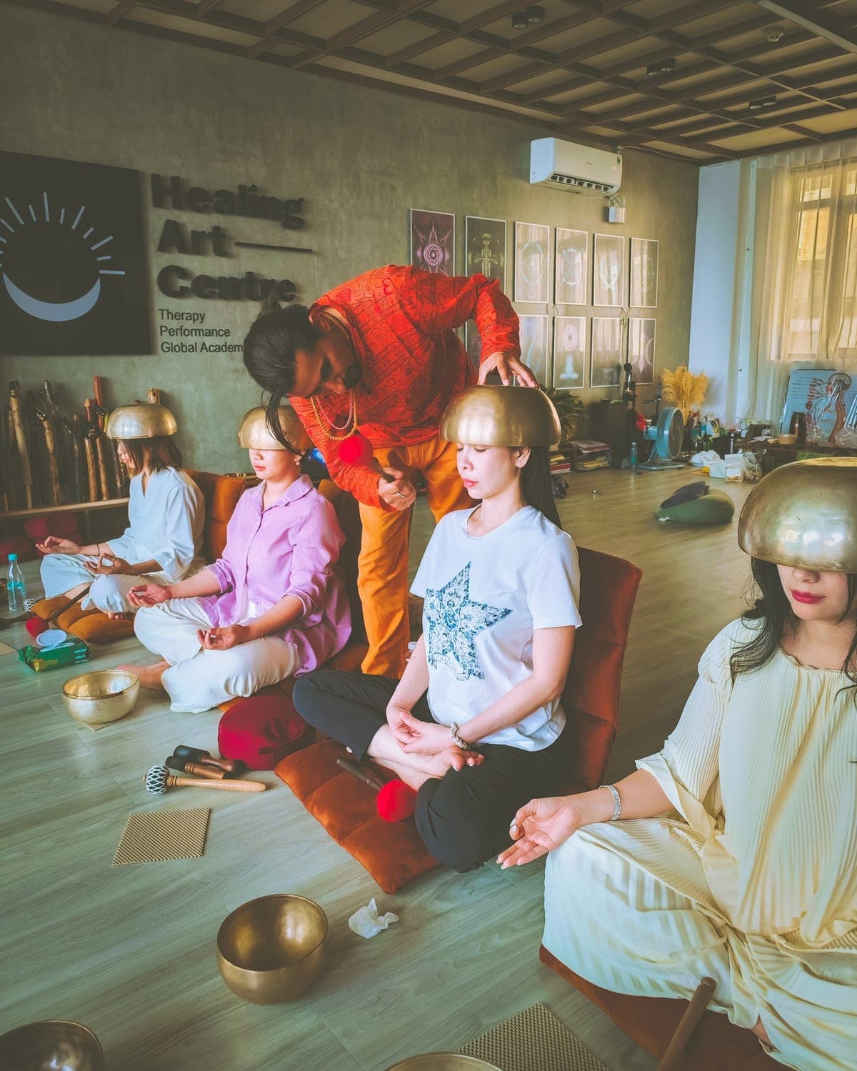 A group sound healing session with singing bowls placed for each participant