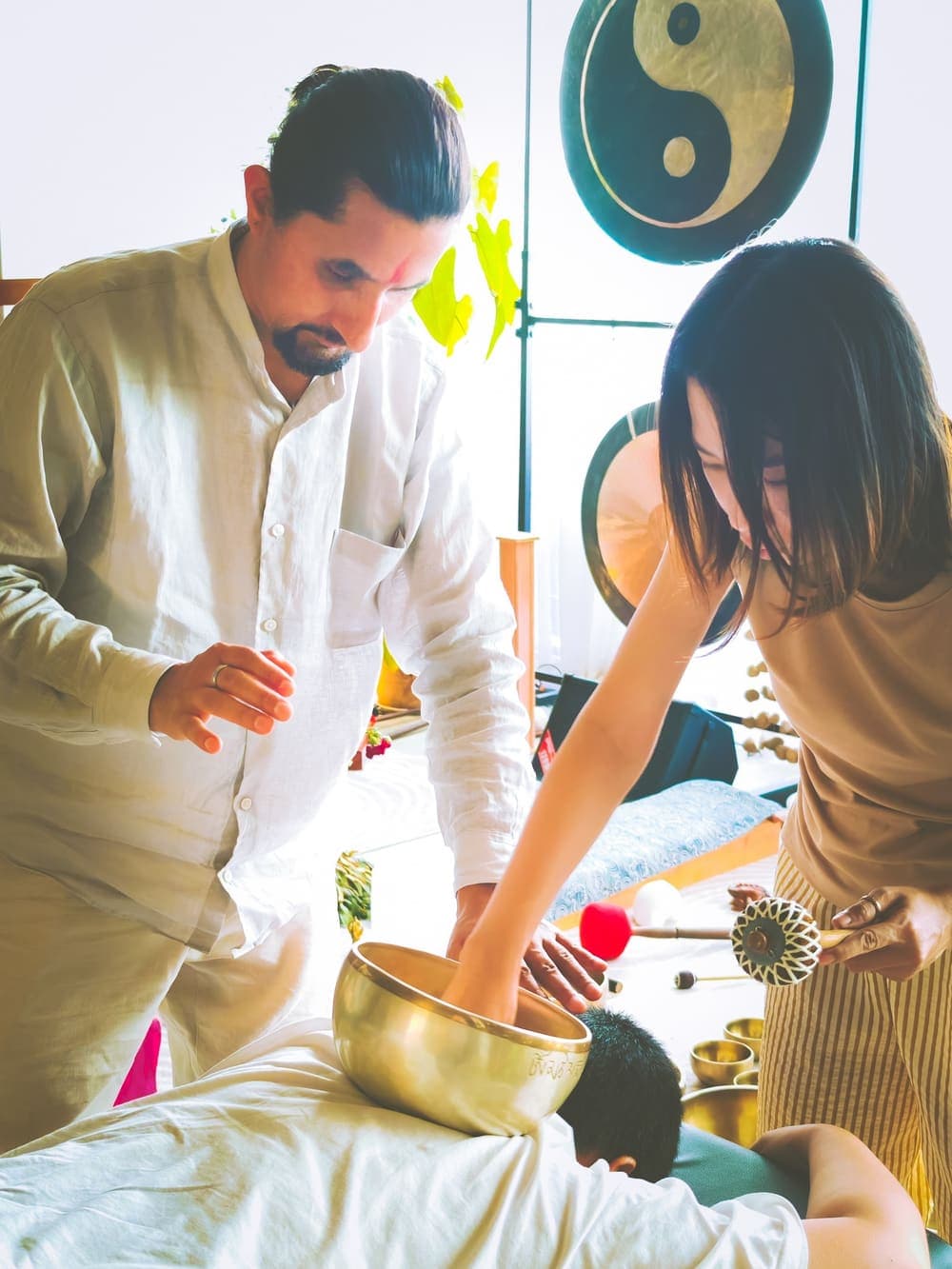Two practitioners working together with Himalayan singing bowls